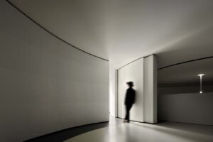 Grey White concrete wall panel with a rippled texture in a contemporary art gallery